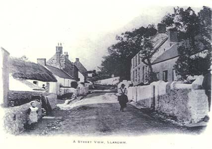 Main Street Llangwm with lady walking towards camera